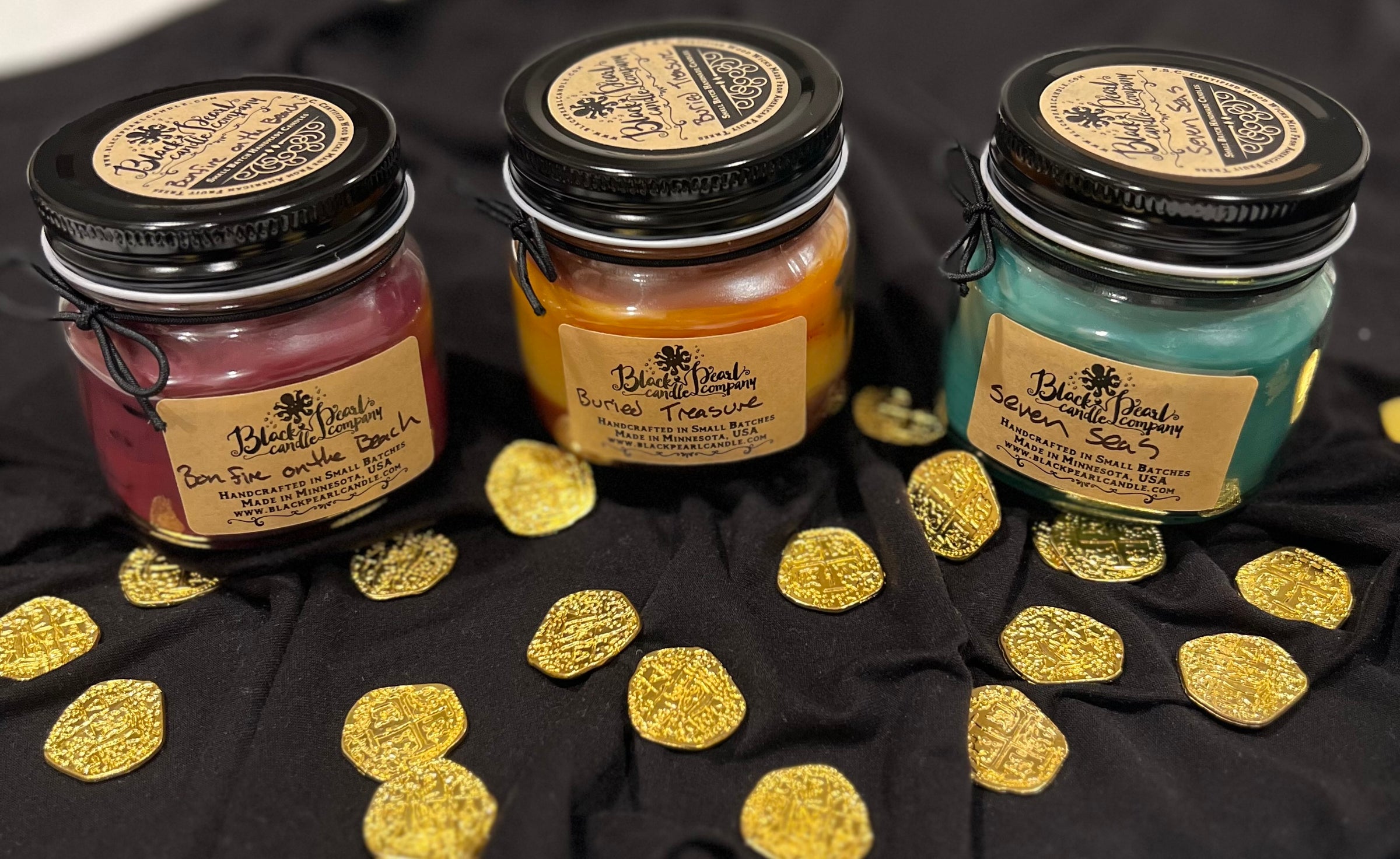 Pirate themed candle gift box containing bonfire on the beach, buried treasure, and seven seas. These three candles help create an adventurous aroma in your home.