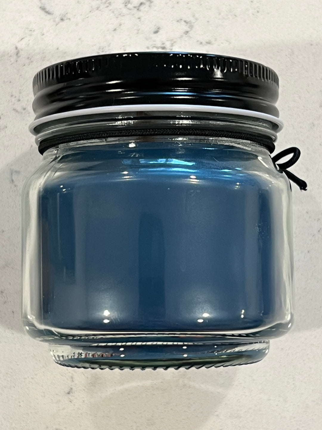 Black Pearl scented candle in 8 oz mason jar with wood wick, soy-paraffin wax, and oceanic fragrance of coral, sea spray, and moss