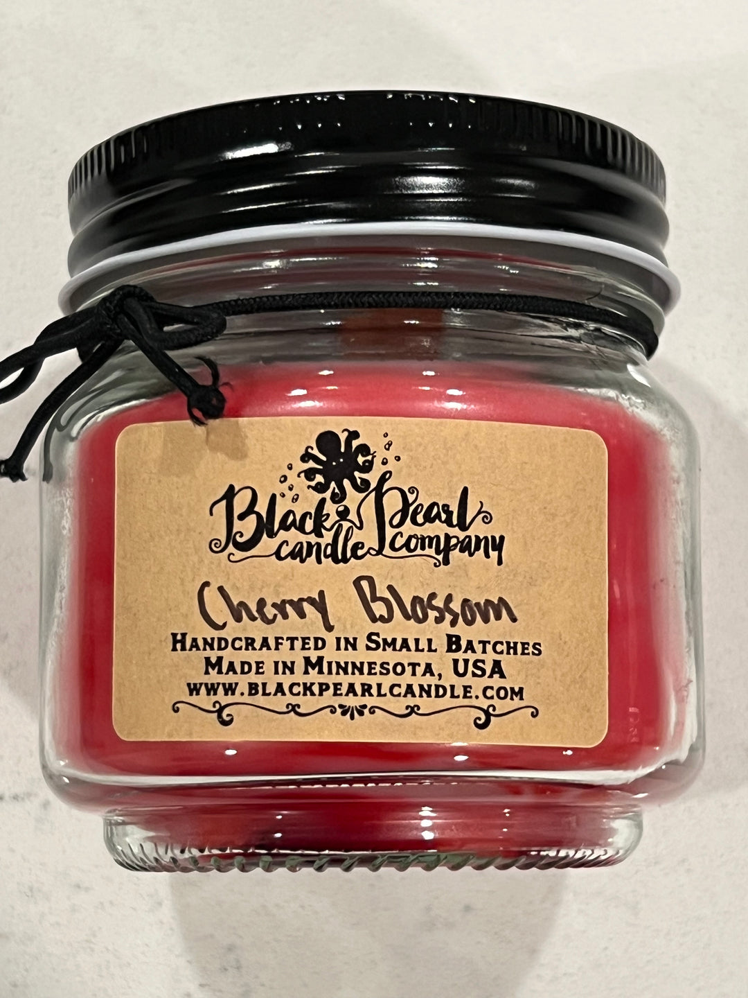 Cherry Blossom scented candle in 8 oz mason jar with wood wick, soy-paraffin wax, and a soft floral fragrance with fresh spring notes
